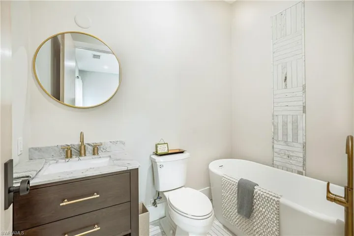 Full bathroom with a freestanding bath and vanity