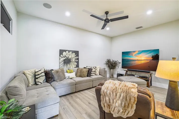 Media Room with wood finished floors, ceiling fan, and recessed lighting, surround sound speakers