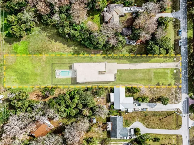 Aerial view of property and surrounding area featuring property boundaries highlighted