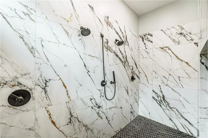Bathroom featuring a marble finish shower