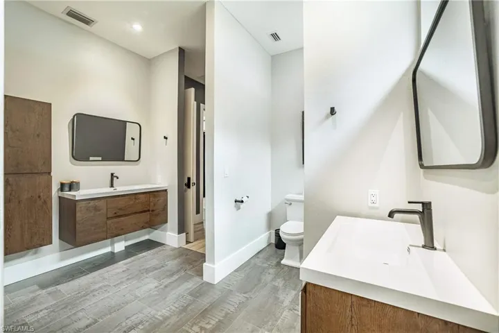 Full bath featuring vanity and wood finish floors