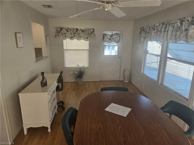 Dining room with wood-type flooring and ceiling fan