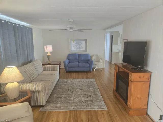 Living room featuring ceiling fan and light hardwood / wood-style flooring