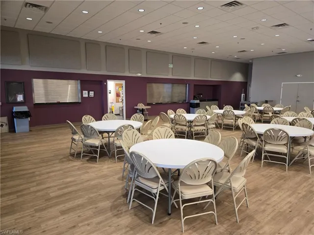 Dining room with a paneled ceiling and light wood-type flooring