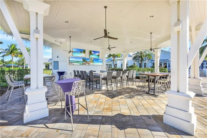 View of patio with an outdoor bar and ceiling fan
