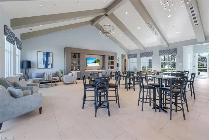 Tiled dining area featuring beamed ceiling, high vaulted ceiling, and a notable chandelier