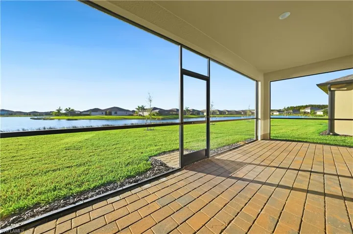 Unfurnished sunroom with a residential view and a water view
