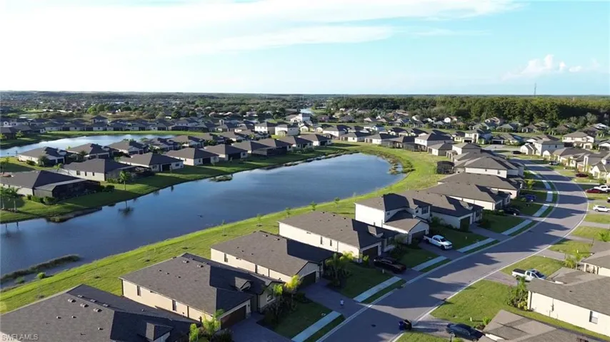 Aerial view of residential area featuring a nearby body of water