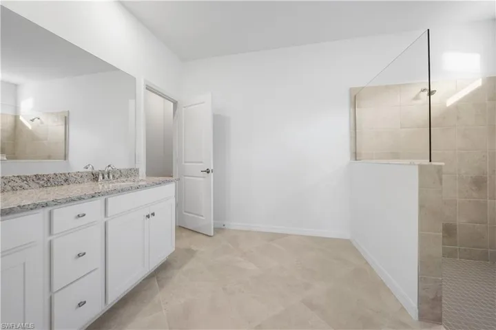 Full bath featuring walk in shower and vanity