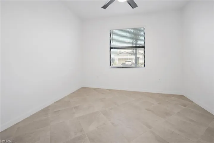 Empty room featuring baseboards