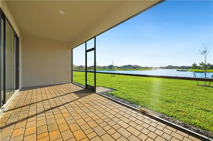 Unfurnished sunroom with a water view and a residential view