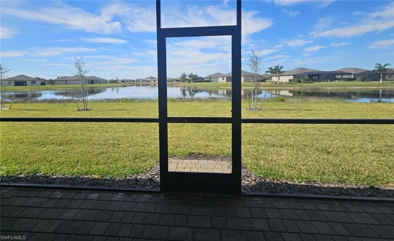 Doorway to outside featuring a residential view and a water view