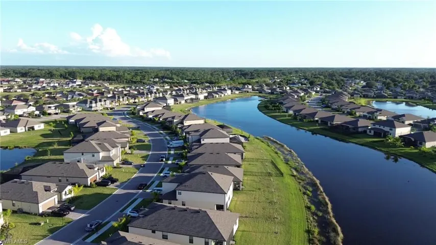 Aerial perspective of suburban area featuring a large body of water