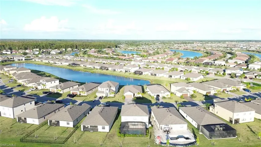 Aerial overview of property's location with a large body of water and nearby suburban area