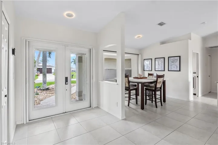 Dining area featuring french doors and light tile patterned floors