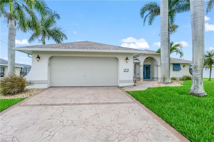 Ranch-style home featuring stucco siding, concrete driveway, a garage, and a front lawn