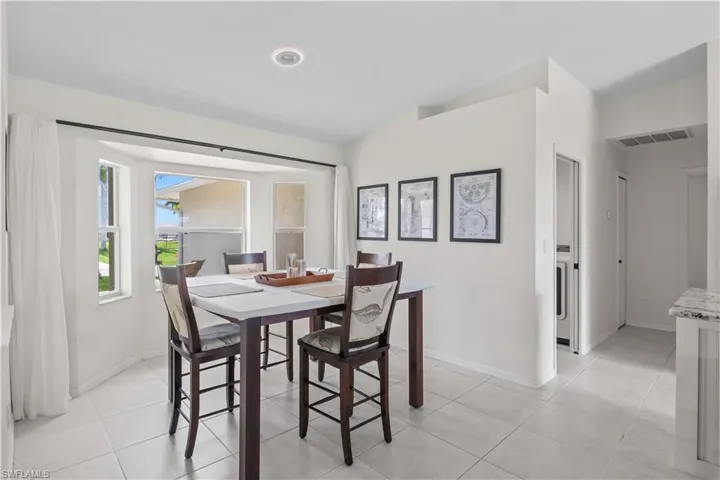 Dining space with baseboards and light tile patterned floors