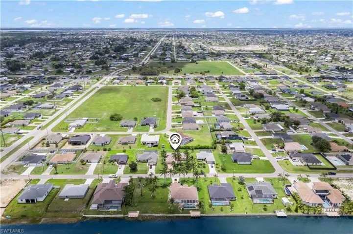 View of property location featuring a nearby body of water and nearby suburban area