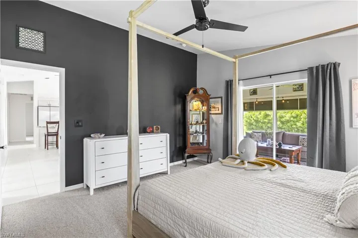 Bedroom featuring carpet flooring, access to exterior, and a ceiling fan