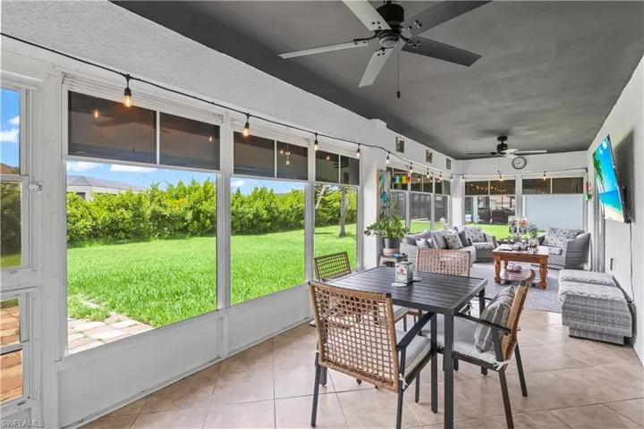 Sunroom featuring ceiling fan and an outdoor hangout area