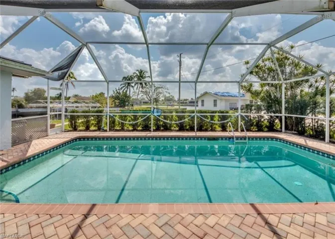 View of pool with a lanai
