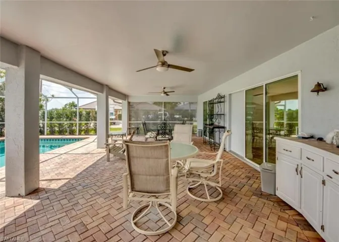 View of patio / terrace with ceiling fan and glass enclosure
