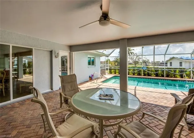 Sunroom / solarium featuring ceiling fan