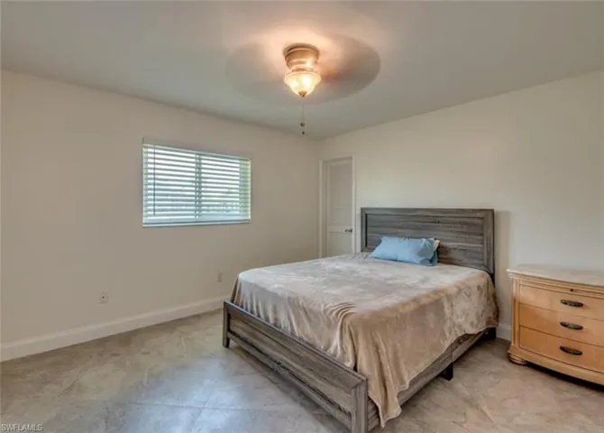 Tiled bedroom with ceiling fan