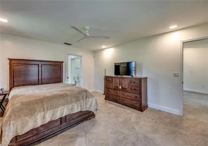 Bedroom with ceiling fan and ensuite bathroom
