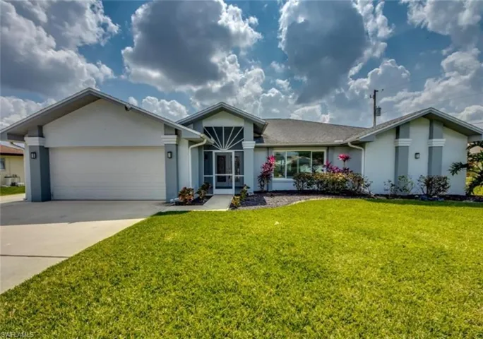 Single story home with a front lawn and a garage