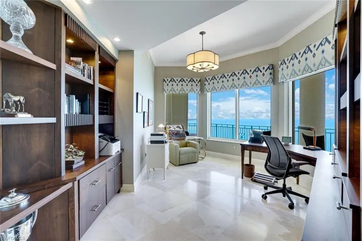 Office space with crown molding, baseboards, a water view, and recessed lighting