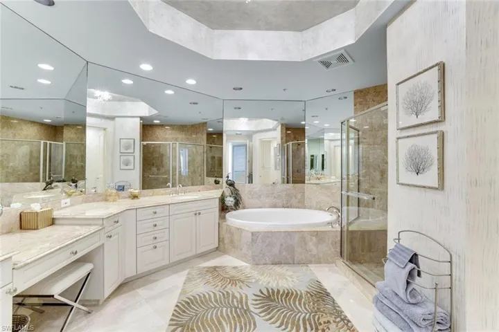 Bathroom with a garden tub, a stall shower, recessed lighting, and vanity