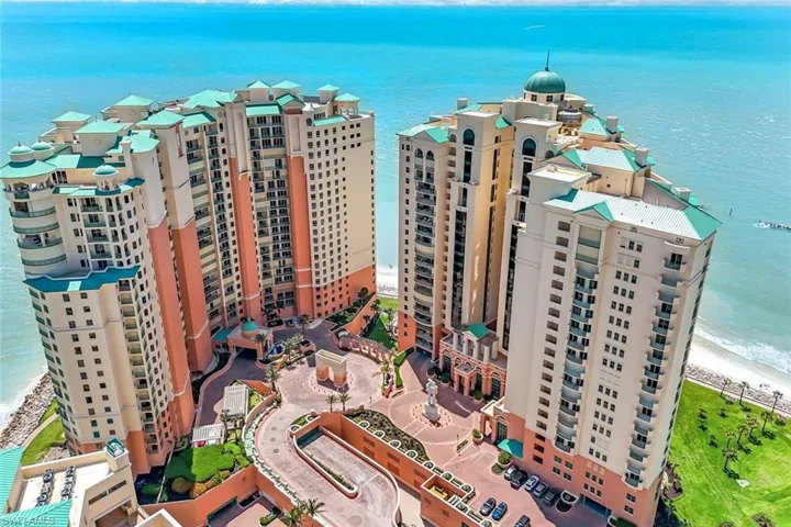 Drone / aerial view of a large body of water and apartment complex / building