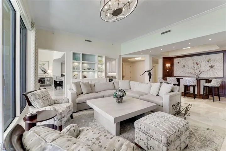 Living room featuring ornamental molding and a chandelier
