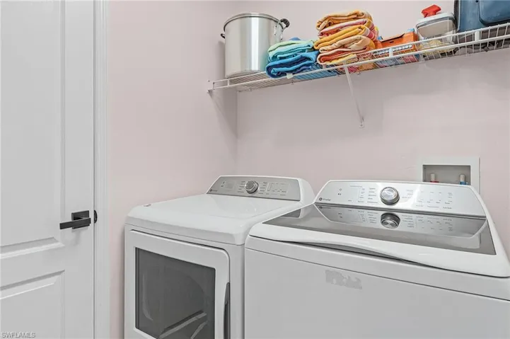 Laundry room with washer and clothes dryer