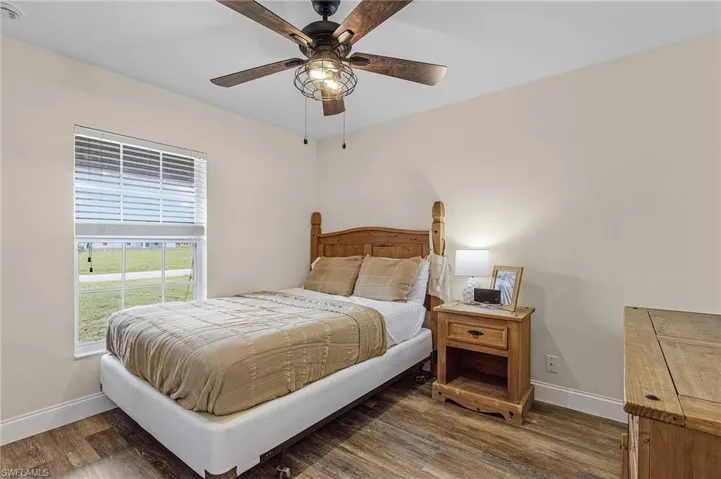 Bedroom featuring dark wood-type flooring and ceiling fan