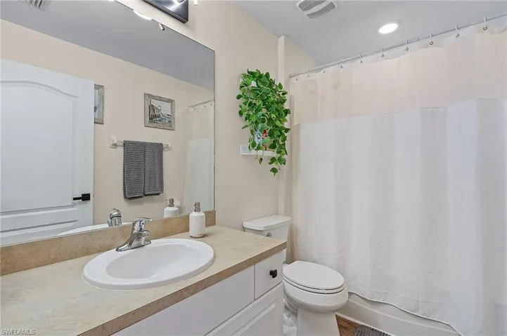 Full bathroom featuring shower / bath combo, vanity, and toilet