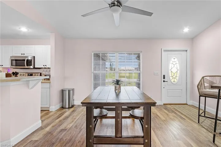 Dining area with light wood-type flooring and ceiling fan
