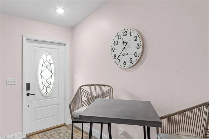 Entrance foyer with hardwood / wood-style floors