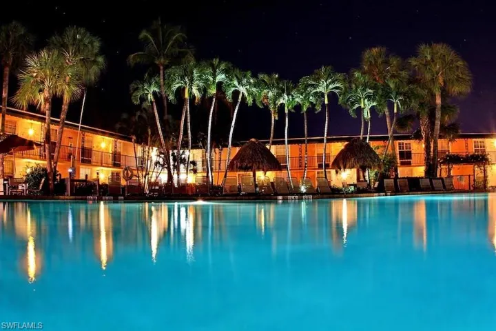 Pool at night with a patio