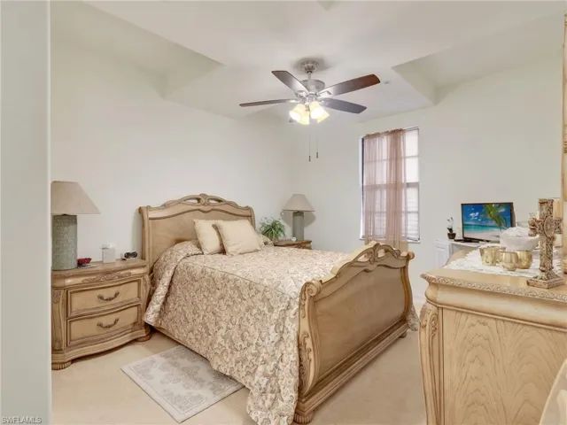 Bedroom featuring light carpet and ceiling fan