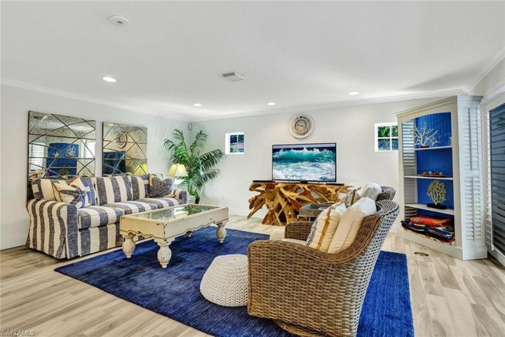 Family Room with crown molding, wood plank tile floors