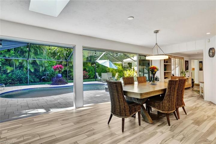 The dining area is adjacent to the kitchen and also opens up to the lanai