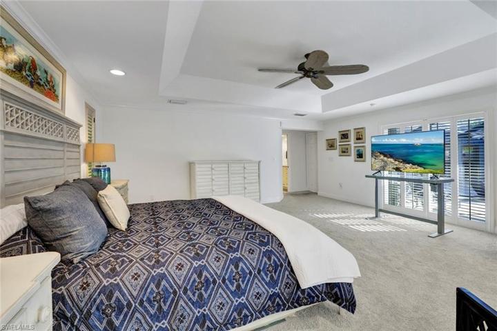 Primary bedroom has sliding doors to the pool area