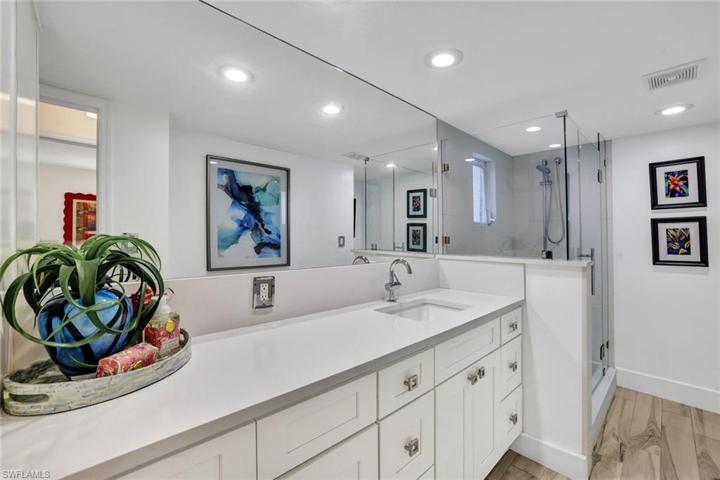Guest bath with oversized vanity and framless shower door