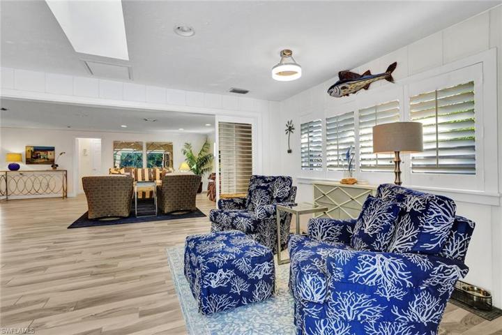 The sunroom is adjacent to the family room and features plantation shutters and a skylight