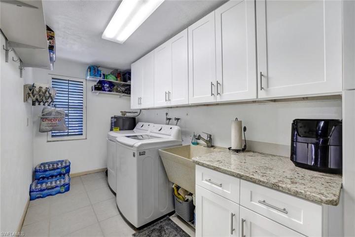 Laundry room with cabinetry and sink