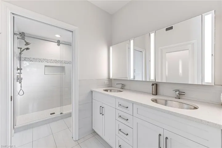 Bathroom featuring vanity and an enclosed shower
