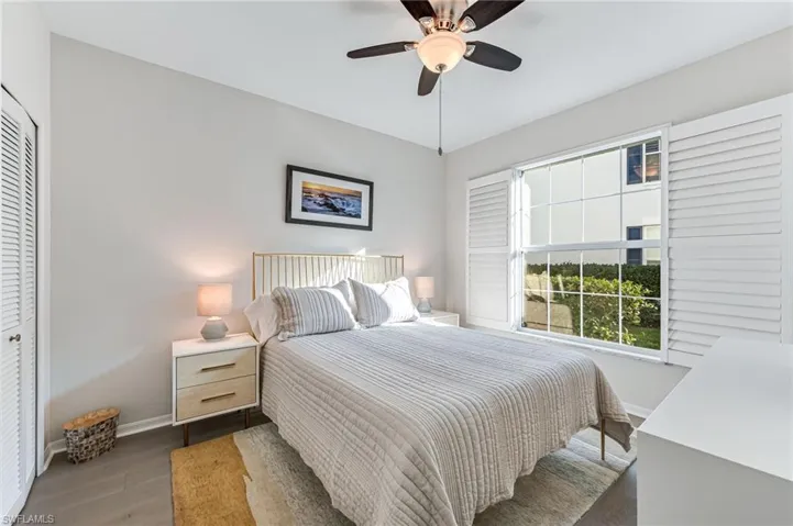 Bedroom with ceiling fan, hardwood / wood-style floors, and a closet