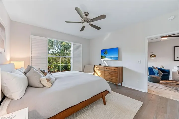 Bedroom with ceiling fan and hardwood / wood-style floors